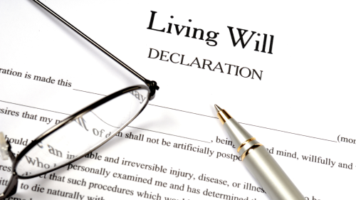 Living will papers with eyeglasses and pen