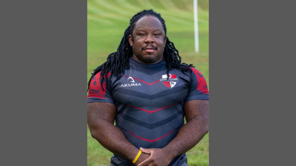 Ike Ezeonwu posing in a grassy field.
