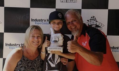 Colton Nelson celebrates a win with mom Danielle and dad Dave after a win at age 11.