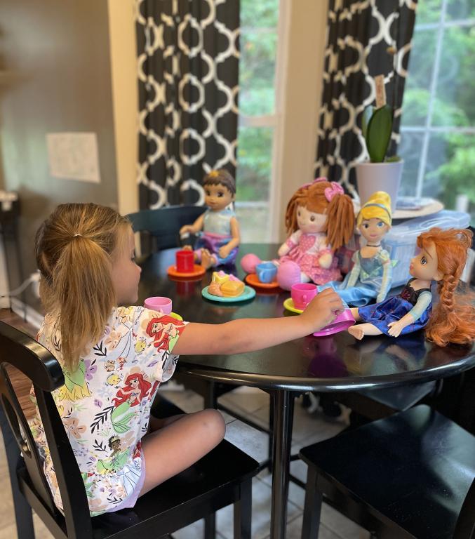 Elliot plays with her dolls