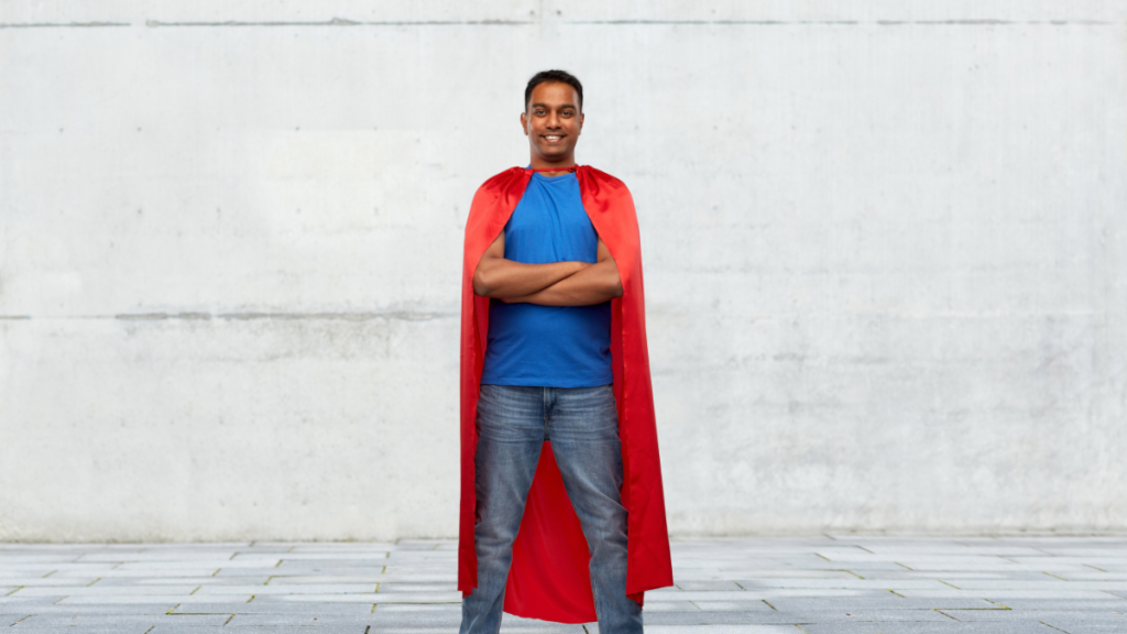 Man in a red cape with arms crossed.