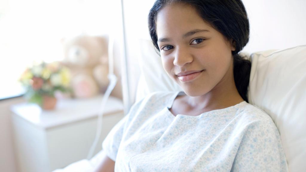 Adolescent girl in a hospital bed.