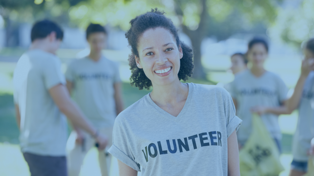 lady wearing gray shirt that reads volunteer