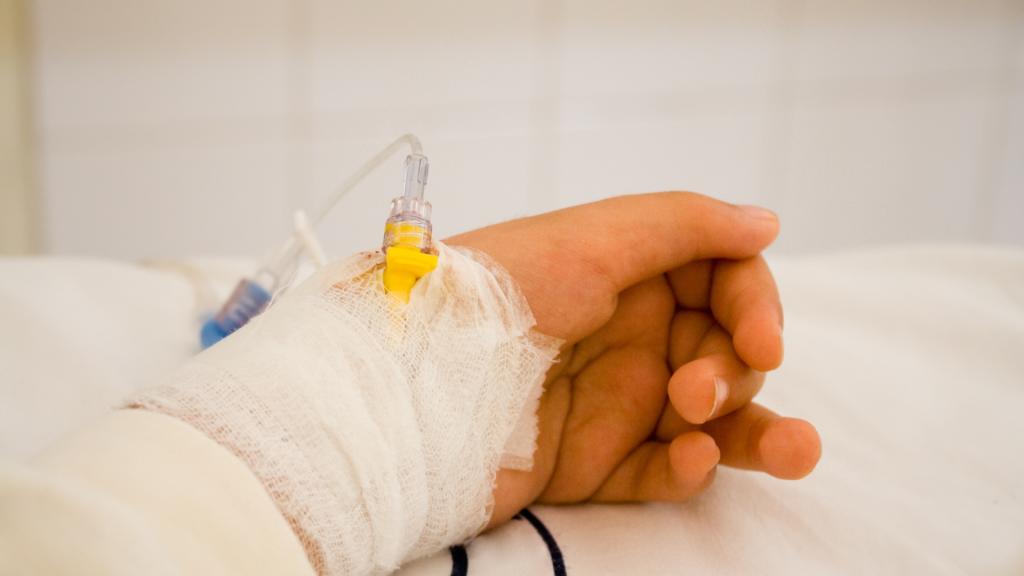 Young child's arm with IV tubing.