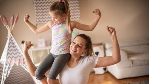 Daugher sitting on mother's shoulders