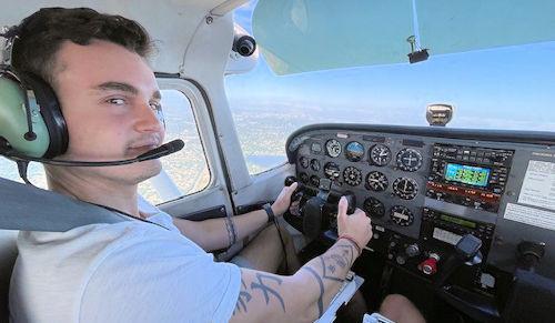 Josh Cash pilots a small plane.