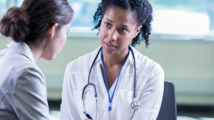 Doctor listening to patient.