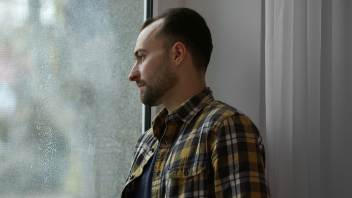 Man staring out of the window.