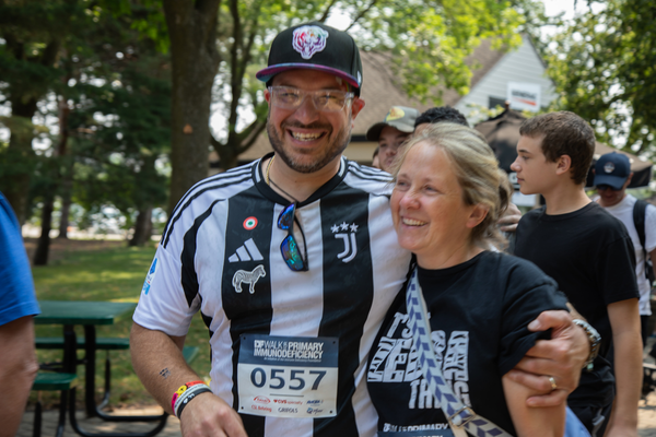 A man and woman smiling arm in arm. 